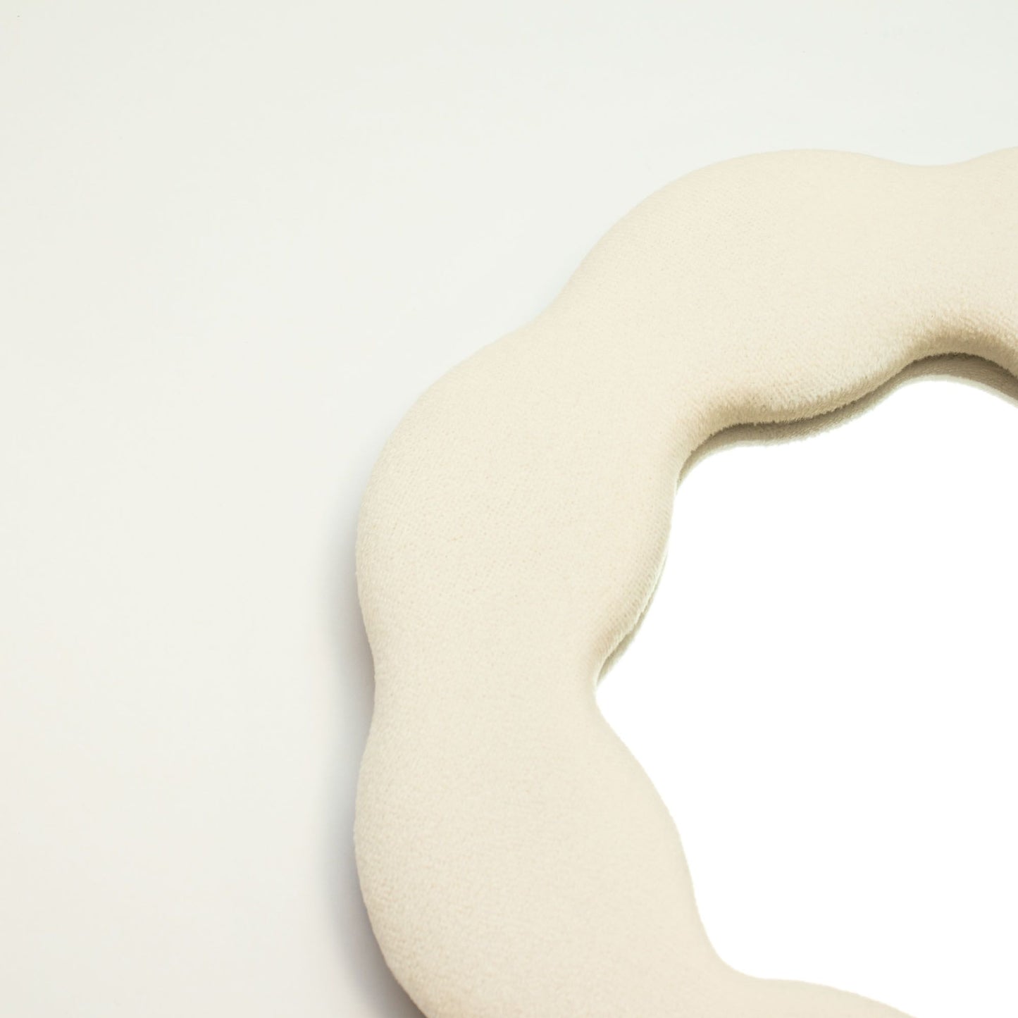 Beige fabric with a wavy texture on a light gray background