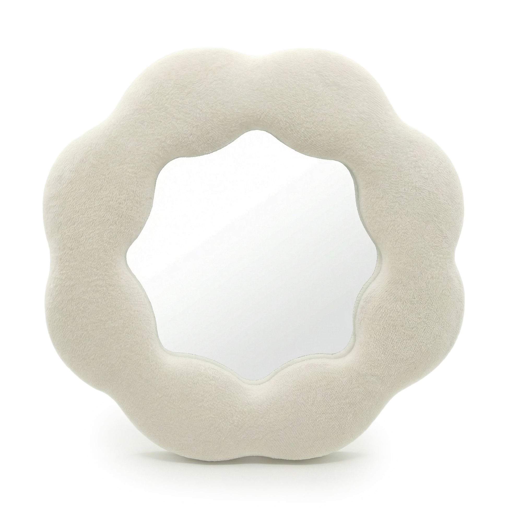Round, beige cushion with a textured surface on a white background