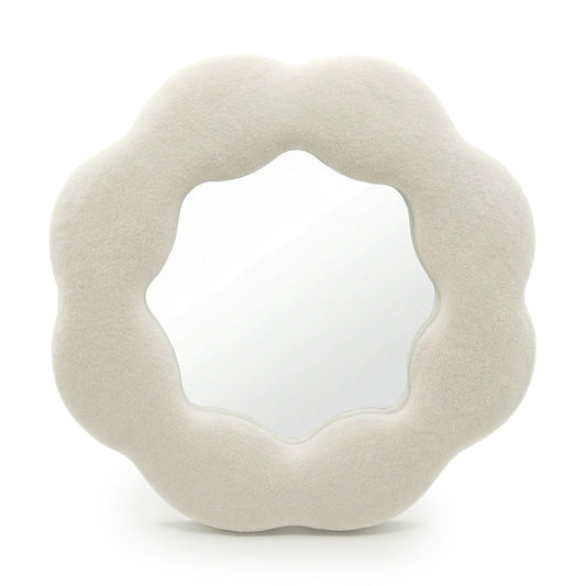 Round, beige cushion with a textured surface on a white background
