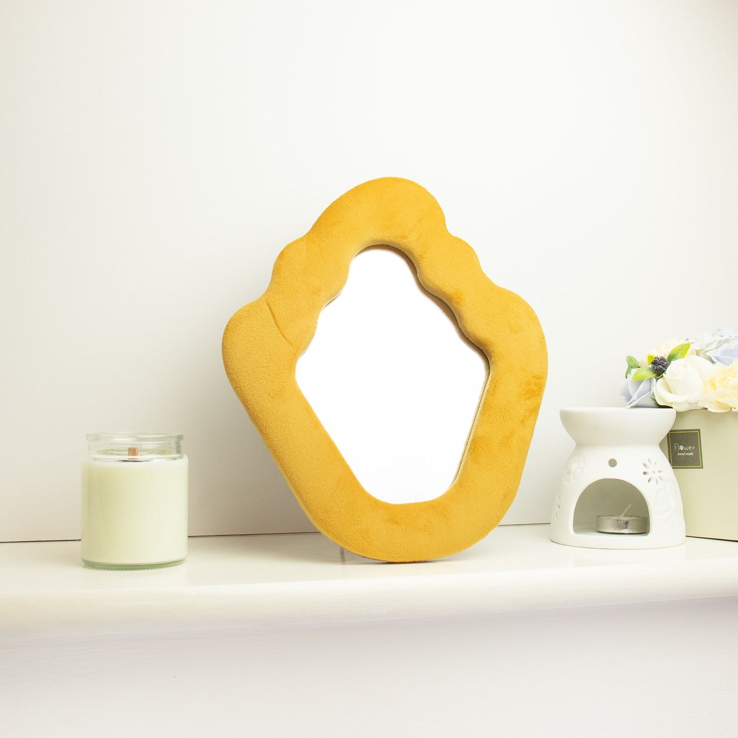 Yellow abstract mirror on a white surface with a white background