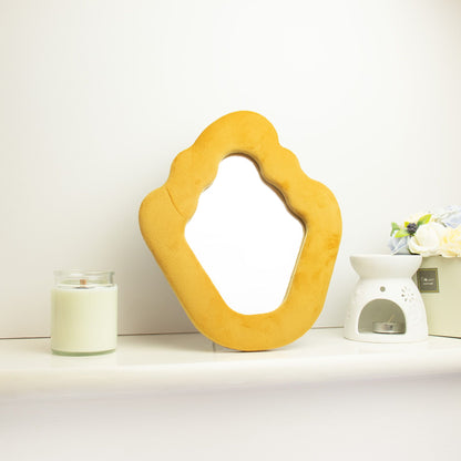 Yellow abstract mirror on a white surface with a white background