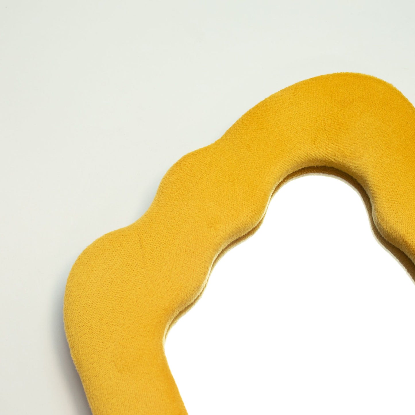 Yellow neck pillow on a light gray background