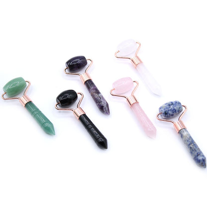 various coloured face rollers against white background